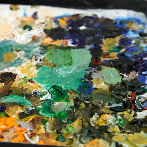 Close-up of a palette with mixed oil paints in various colors