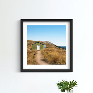Framed art print of a relax hut on mt Robert with a clear blue sky.